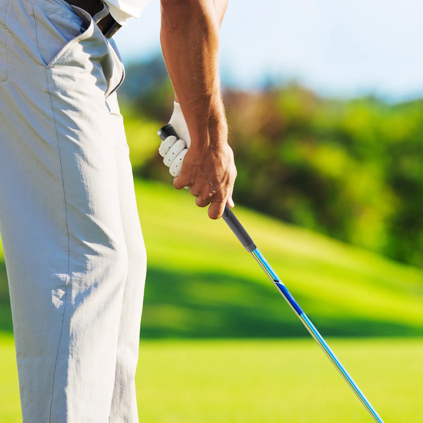 Golfer swinging with Yamato Jumbo oversize grip on grass